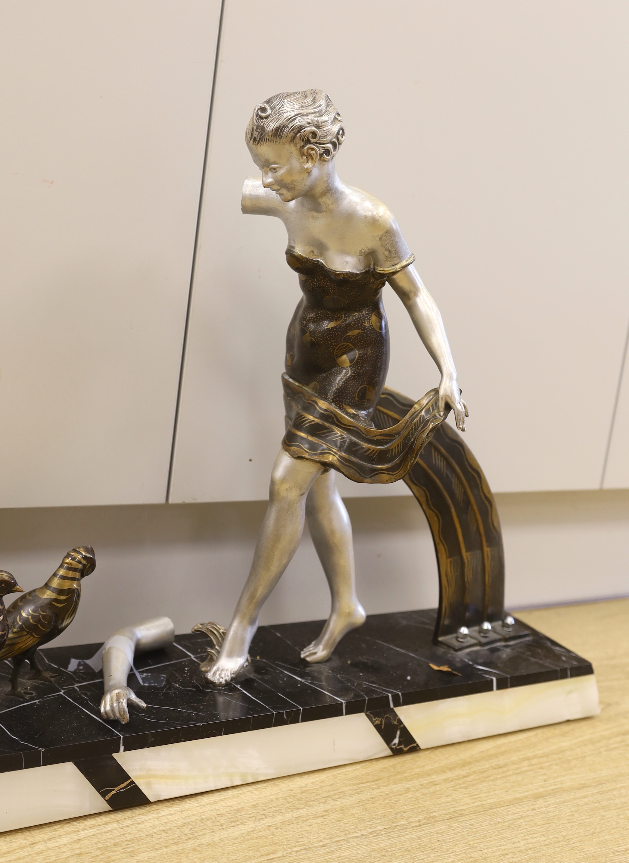 A French Art Deco spelter and marble figure group, 49cm tall (a.f.)